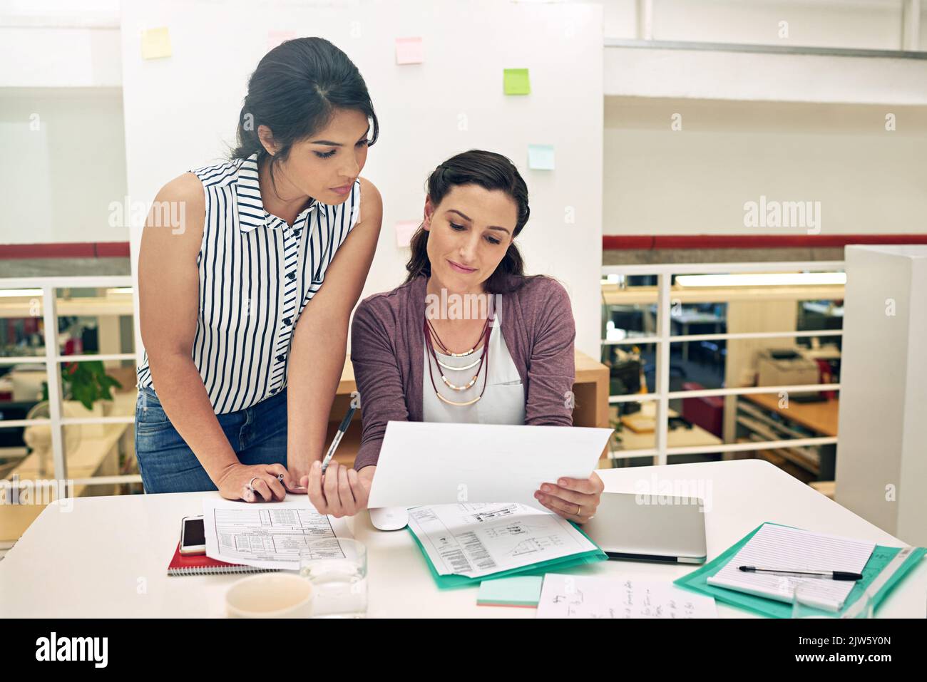 Someone Getting Insight Getting her coworkers insight. a two colleagues having a meeting in a ...