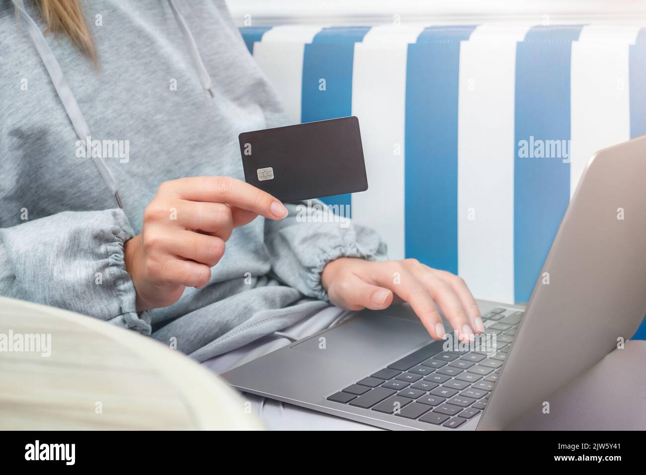 Girl pays for purchases with a card online shopping Stock Photo