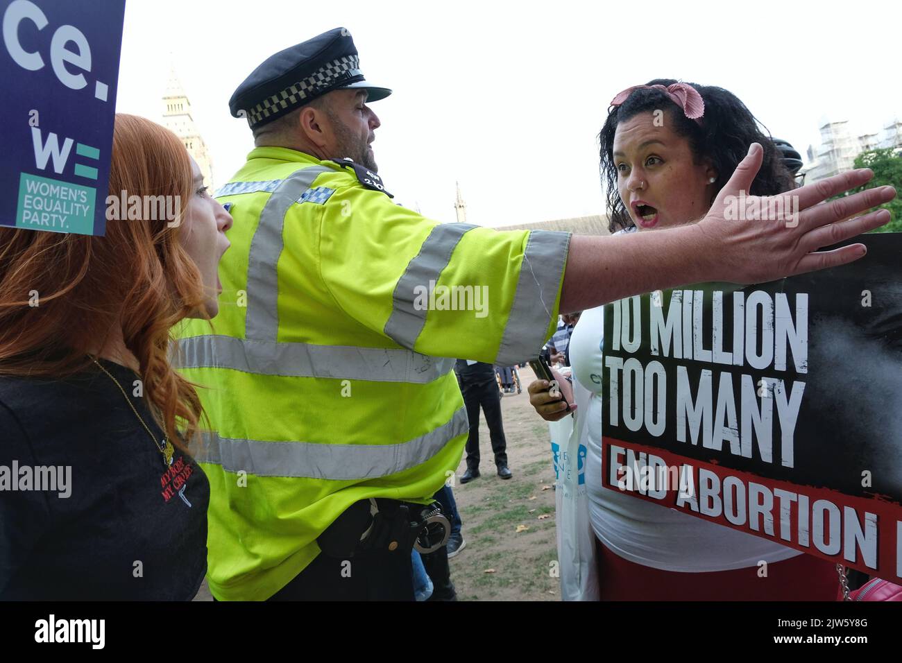 London, UK, 3rd September, 2022. A police officer stands between activist Patsy Stevenson and a pro-life protester as they debate with one another. Women's pro-choice activists assembled on Parliament Square in a counter protest against the annual March for Life event, attended by Evangelical Christians and Catholics amongst others, who oppose abortion, believing life begins from conception. Pro-choice groups say the overturning of Roe v Wade has emboldened anti-abortionists. Credit: Eleventh Hour Photography/Alamy Live News. Stock Photo