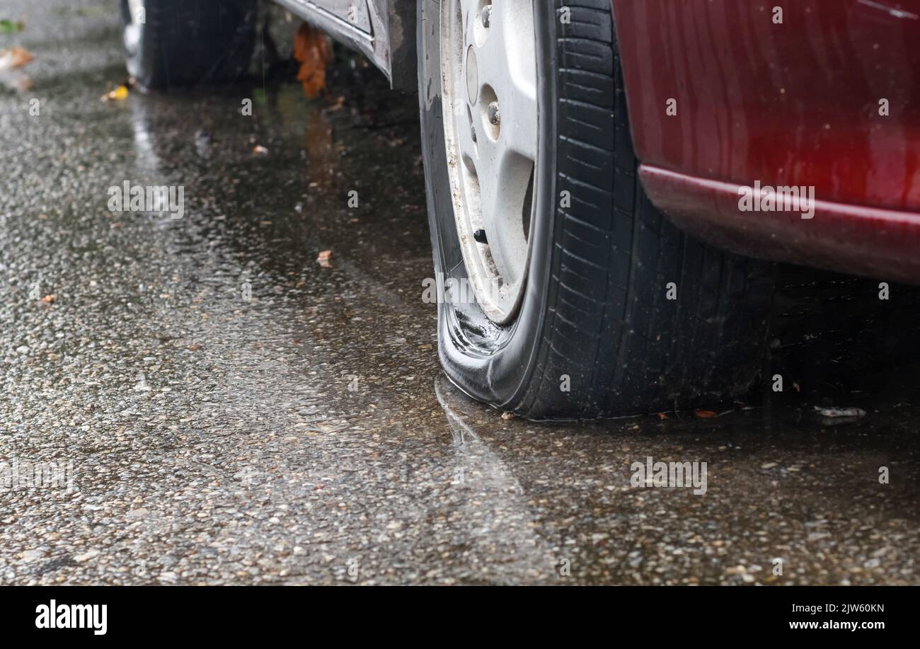 Flat tire car in rainy day on street Stock Photo Alamy
