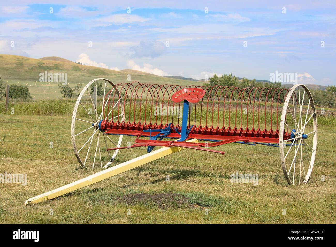 Vintage farm cultivator in a field on the Bar U Ranch National Historic Site, southern  Alberta, Canada. Stock Photo