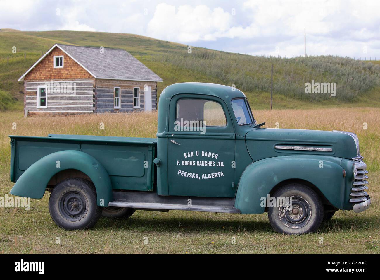 Mercury half ton 1940s old green farm truck with logo on Bar U Ranch National Historic Site in southern Alberta, Canada Stock Photo