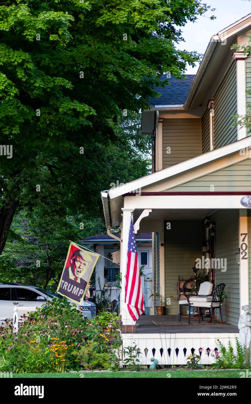A Donald Trump flag and a US flag displayed from the porch of a home in Auburn, Indiana, USA. Stock Photo