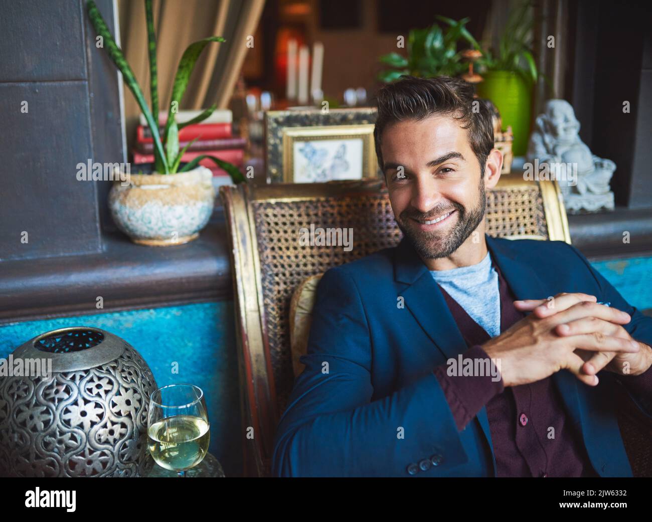 You up for a drink. Cropped portrait of a young man sitting in a bar