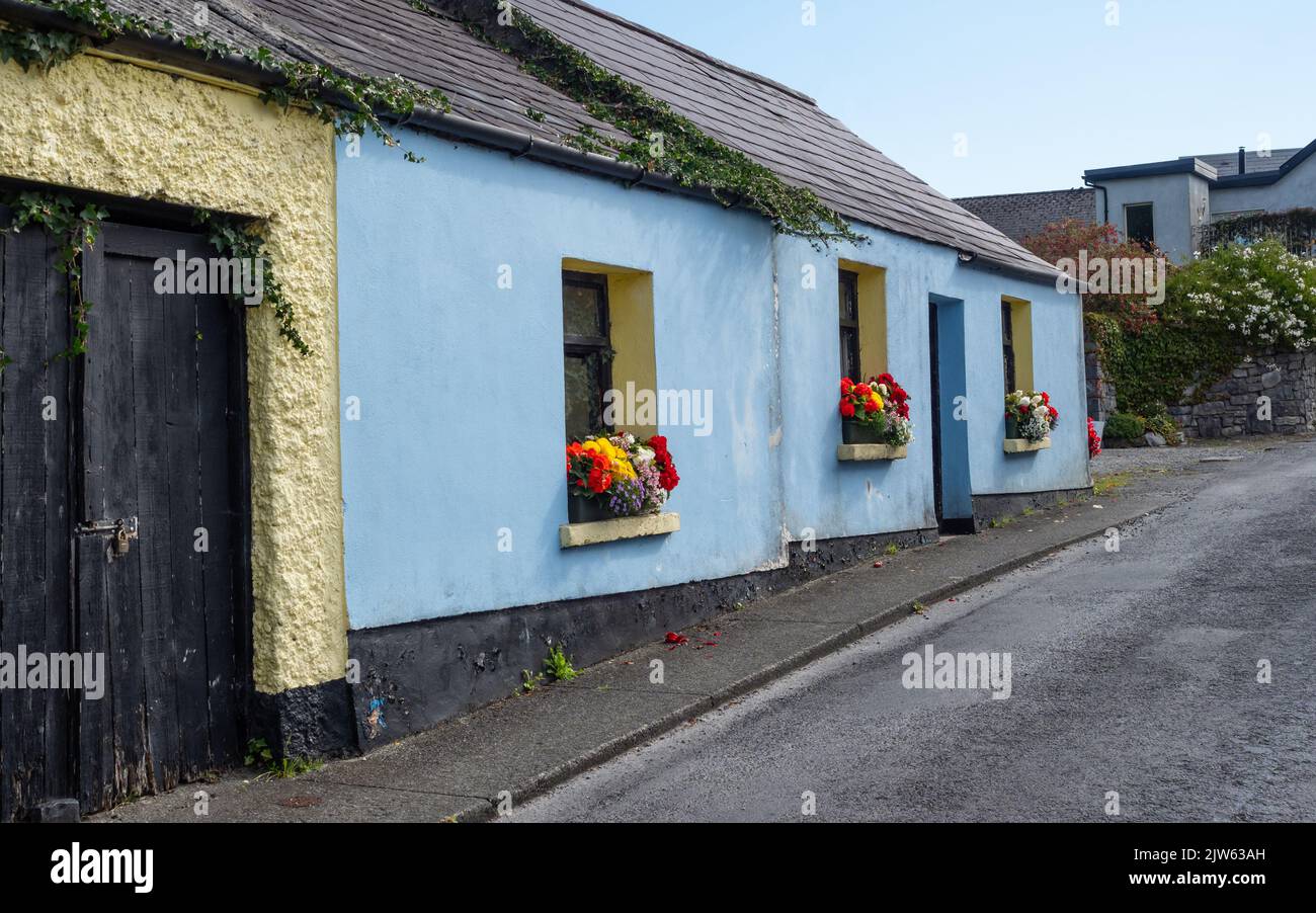 A blue traditional cottage in a street in Cong, on the border of County Galway and County Mayo in Ireland. Stock Photo