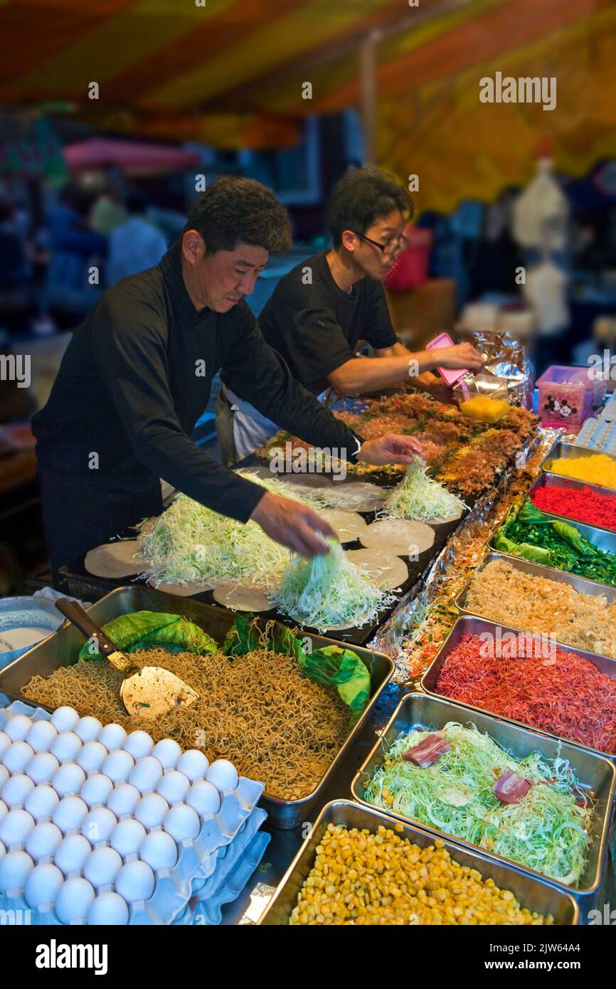 Okonomiyaki (savoury pancakes) prepared at Takadanobaba obon festival in Tokyo, Japan Stock Photo