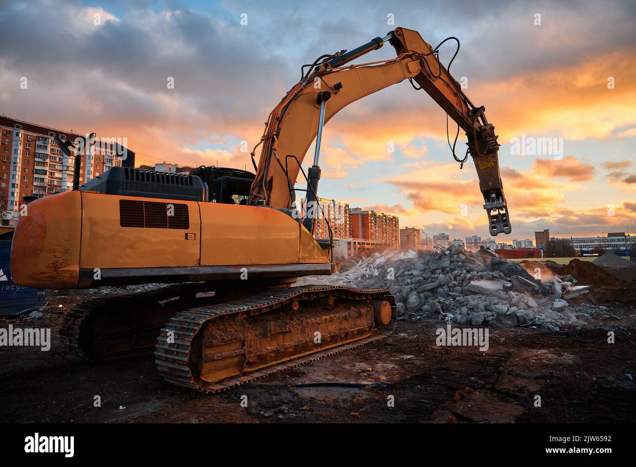 Excavator with concrete crusher on rig at demolition site Stock Photo