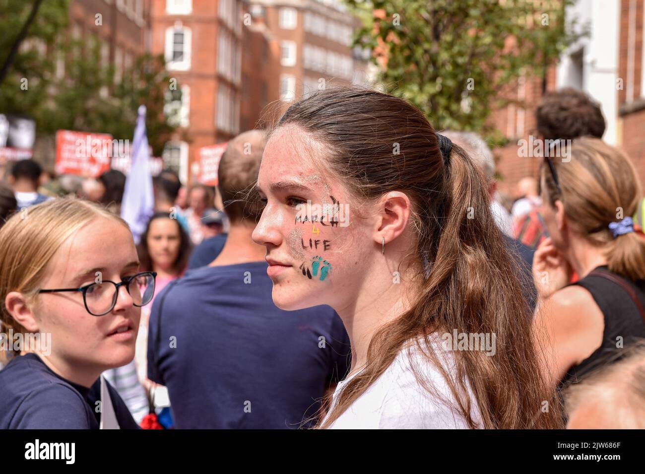 A protester with painting on her face saying "March For Life" takes part during the demonstration. Anti-Abortion activists and "Pro Life" protesters marched through central London to Parliament Square to mark their opposition to the abortion law in the UK. (Photo by Thomas Krych / SOPA Images/Sipa USA) Stock Photo