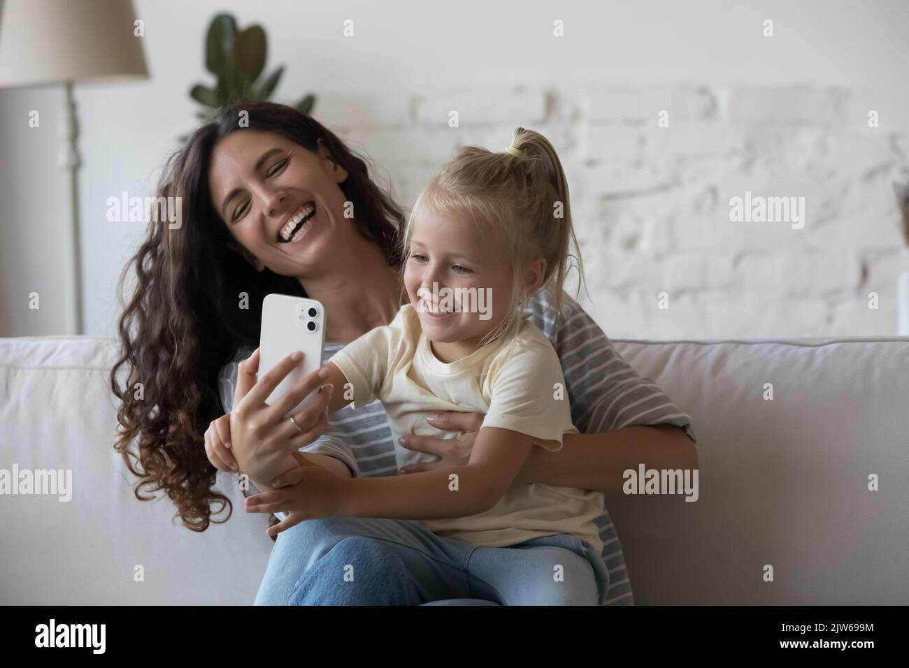 Mom and kid using modern smartphone at home Stock Photo - Alamy