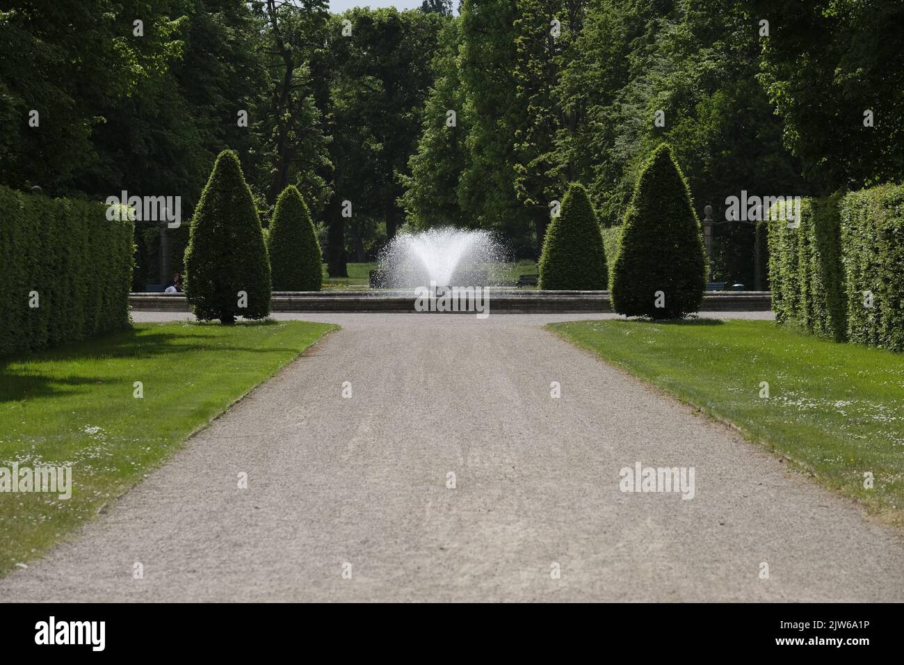 A park with trees and water fountain in the middle Stock Photo - Alamy