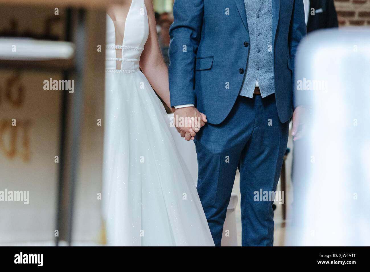 Bride and Groom holding hands during their wedding ceremony Stock Photo