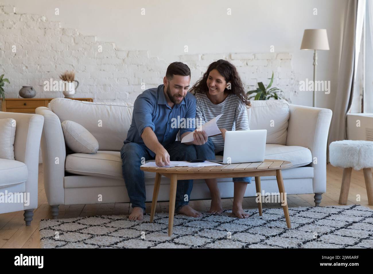 Wife and husband pay bills, sorting out papers feel satisfied Stock Photo