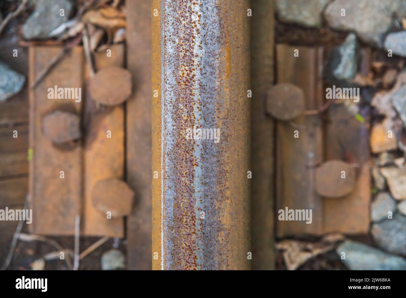 old rusty rail close-up on a rotten wooden railway sleeper  Stock Photo