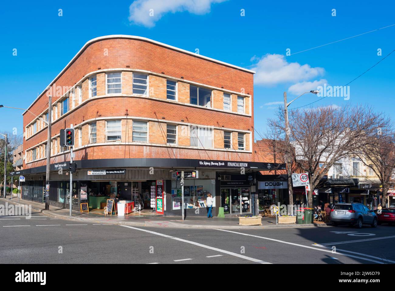 A rare three-storey corner brick building in the Inter-War Functionalist style built around 1940 in Summer Hill, New South Wales, Australia Stock Photo