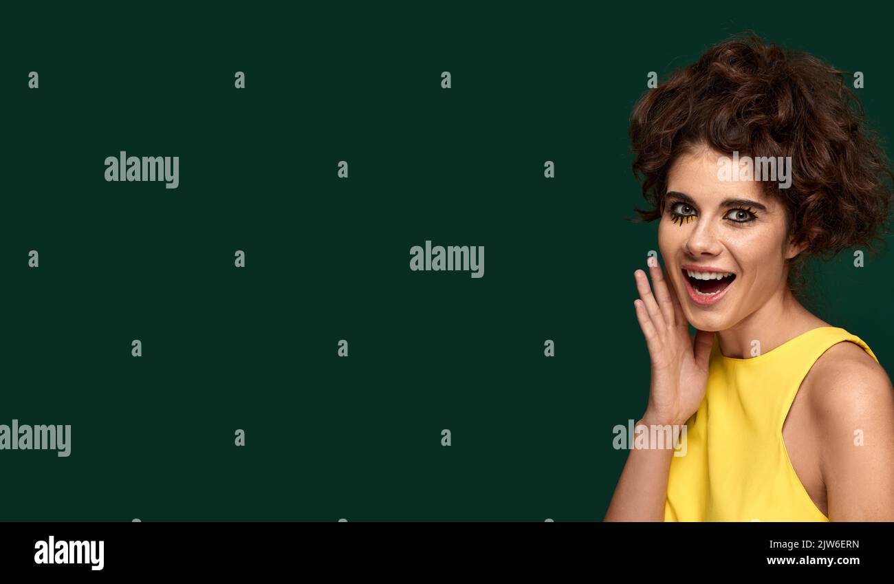 surprised woman in yellow dress starring with opened mouth Stock Photo ...
