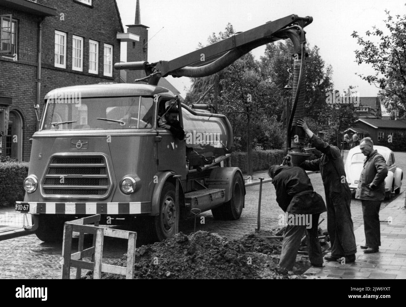 Sewer utility workers cleaning Black and White Stock Photos & Images ...