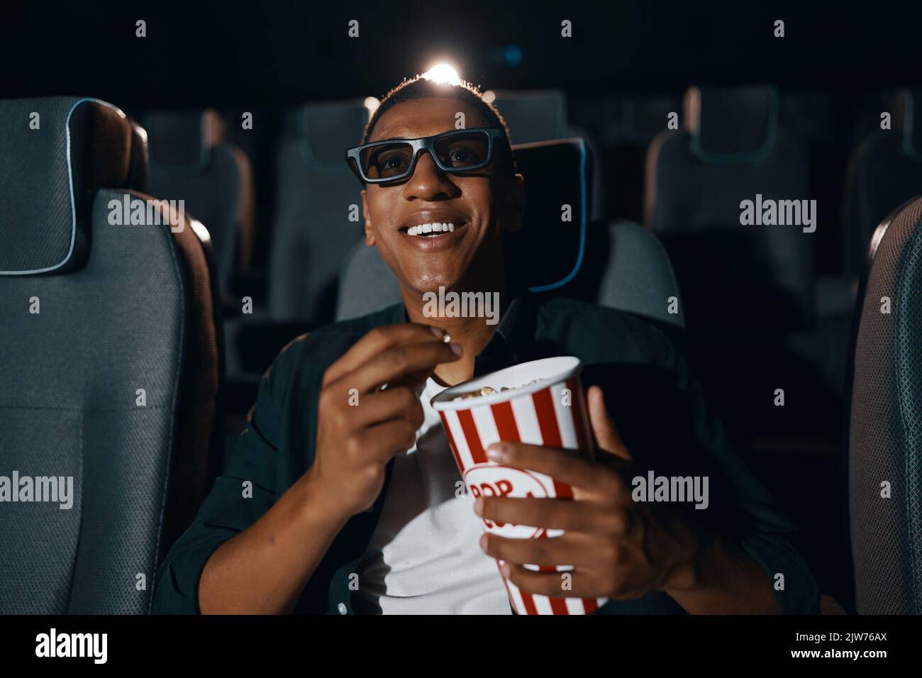 A man is watching a movie in the cinema comedy. Stock Photo