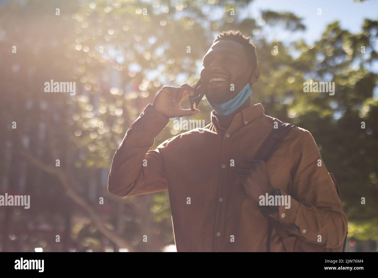 African american man walking talking on a smartphone Stock Photo