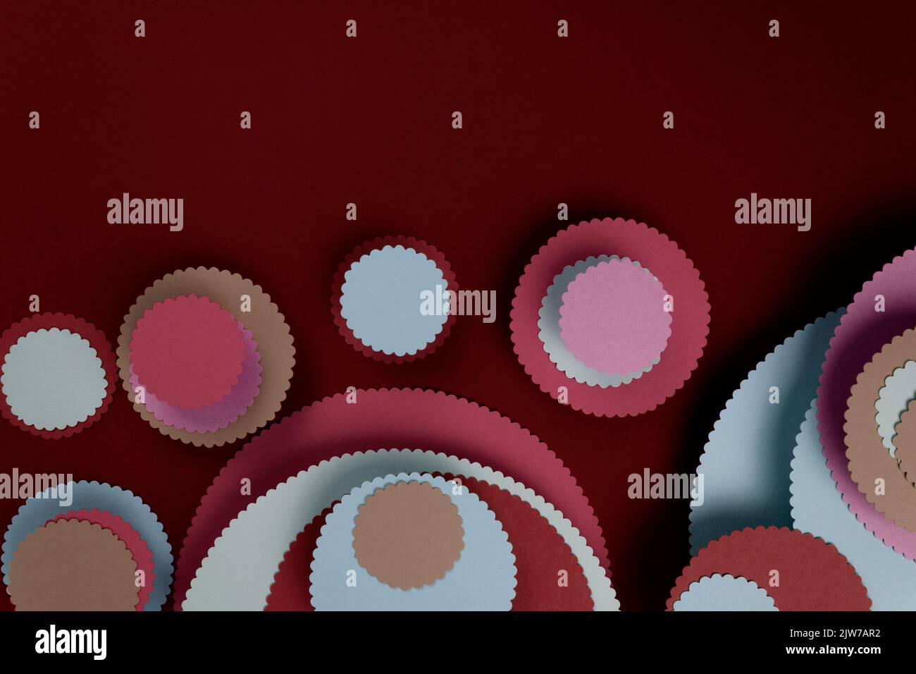 Abstract colored paper circles shapes in blue background. Minimalist