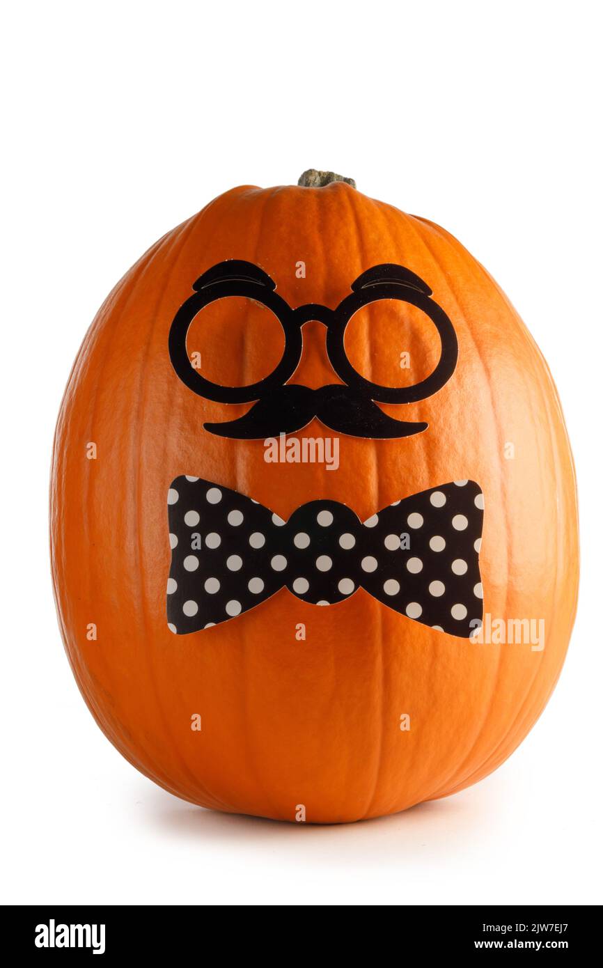 Fun halloween pumpkin in glasses and bow tie isolated on white background Stock Photo