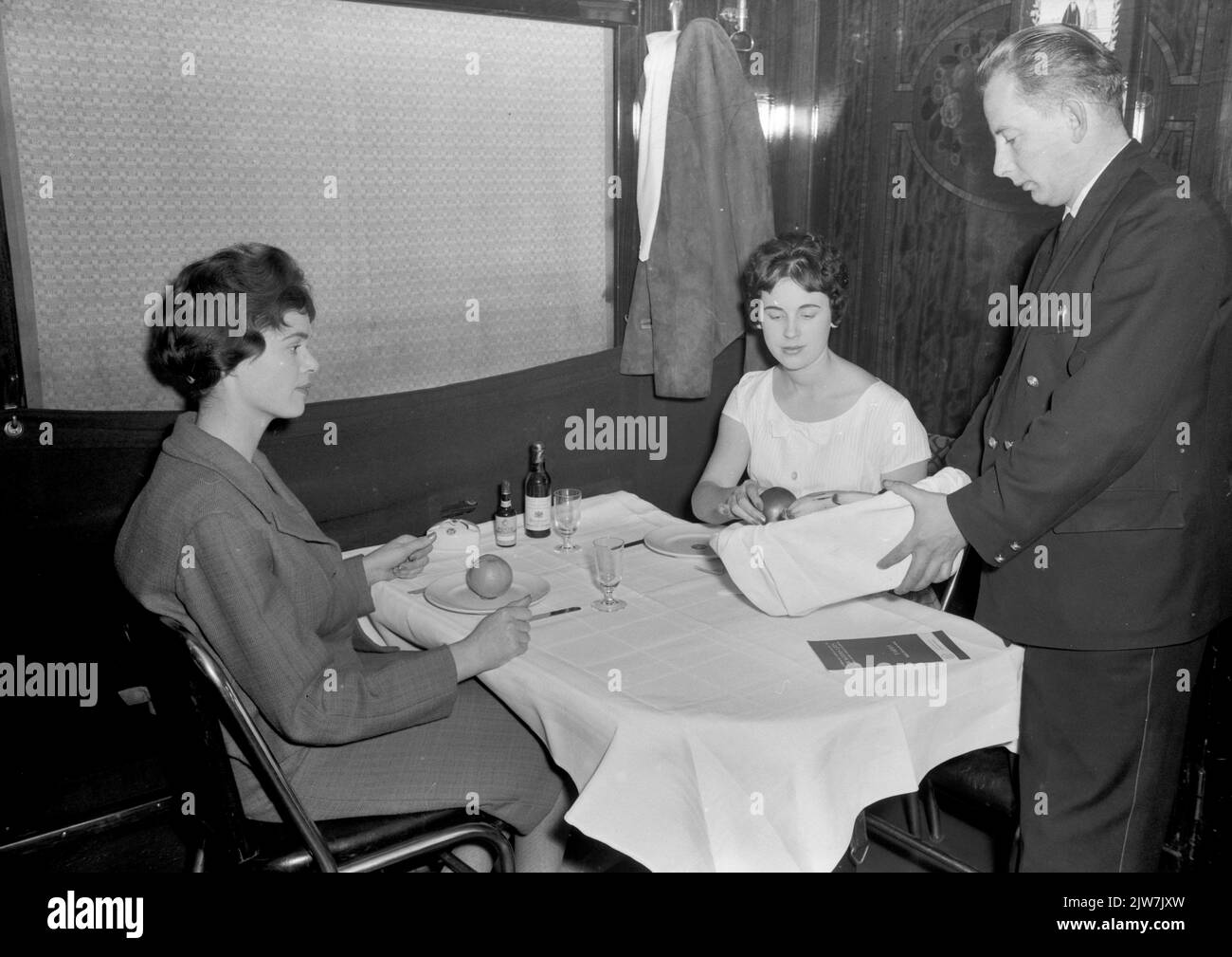 Image of a waiter and two train passengers in a restoration car Stock ...