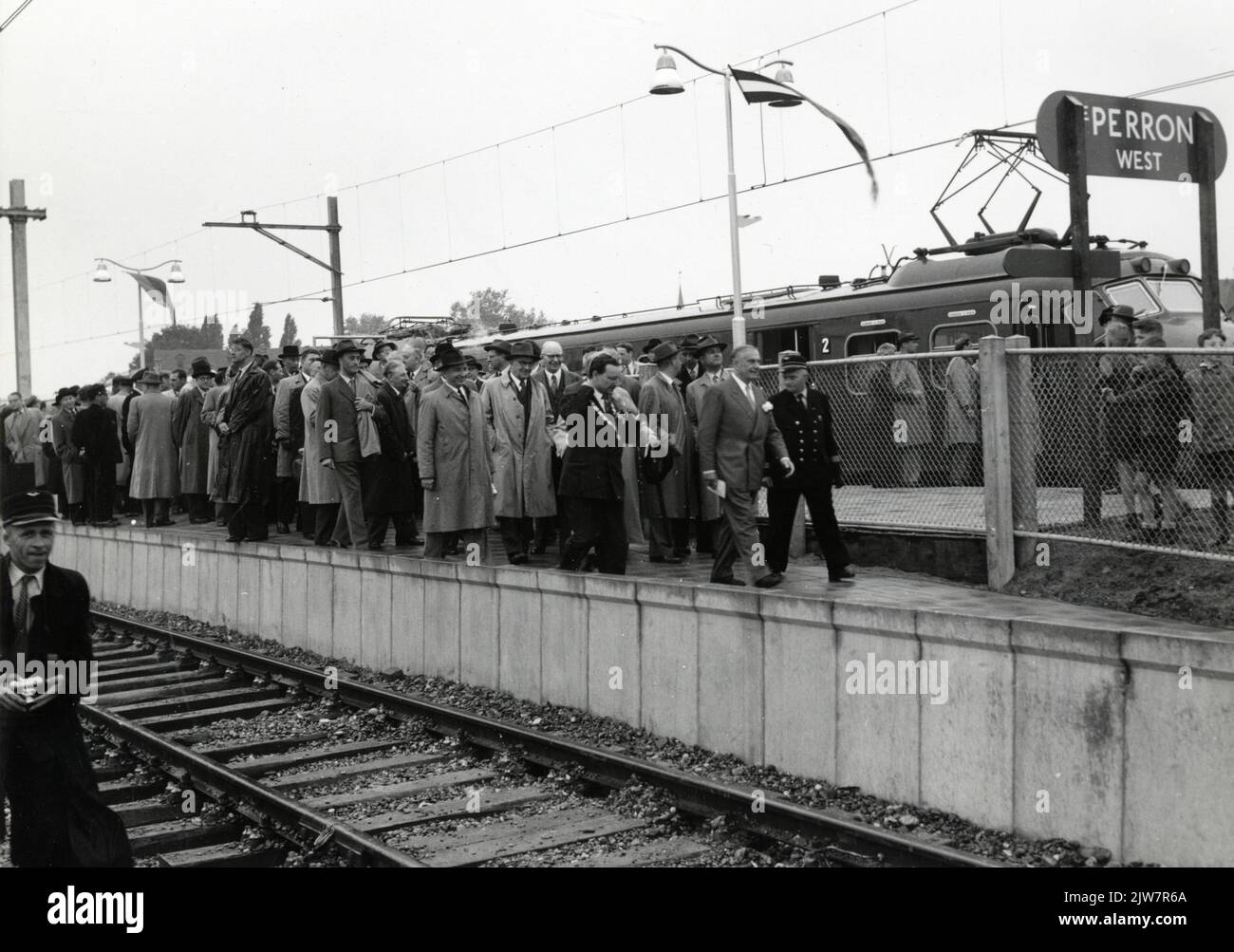 Image of president director Dr. Ir. F.Q. Den Hollander of the N.S. and his consequence on the platform of the N.S. station in Venlo in Venlo, after the party train arrived on the occasion of the electrification of the Eindhoven - Venlo railway line. Stock Photo