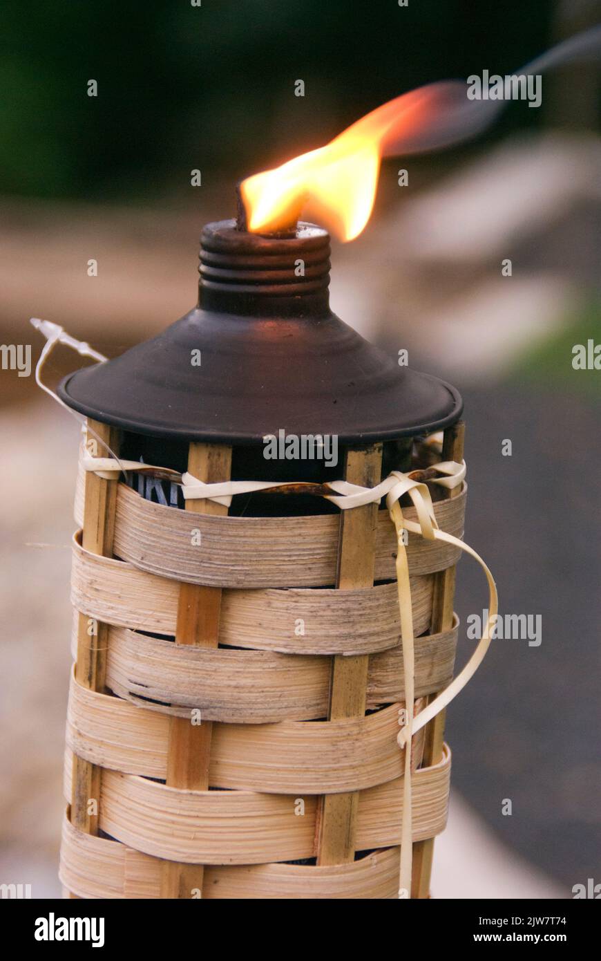 A vertical shot of a tiki torch burning on a beach Stock Photo Alamy