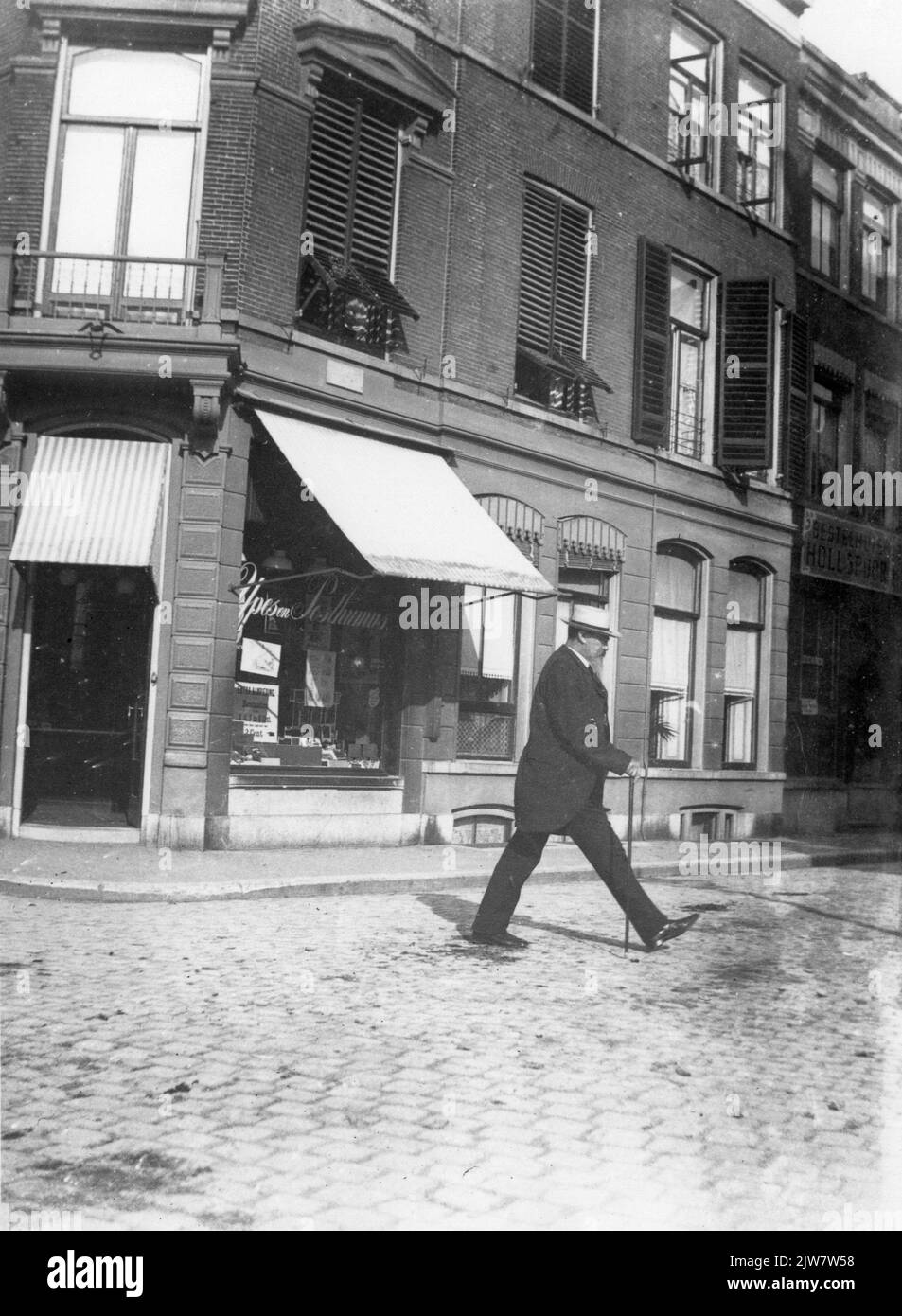 Image of Anthony Grolman who crosses the Lange Jansstraat in Utrecht; In the background the Winkelwoonhuis Voorstraat 1. Stock Photo