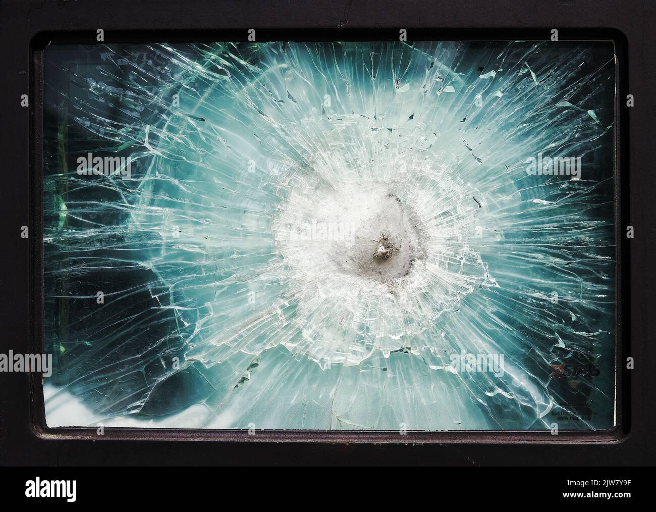 Bulletproof glass. Armored car after the shelling. Armored glass after of a direct hit from an automatic weapon. Safety glass after being hit by a bul Stock Photo