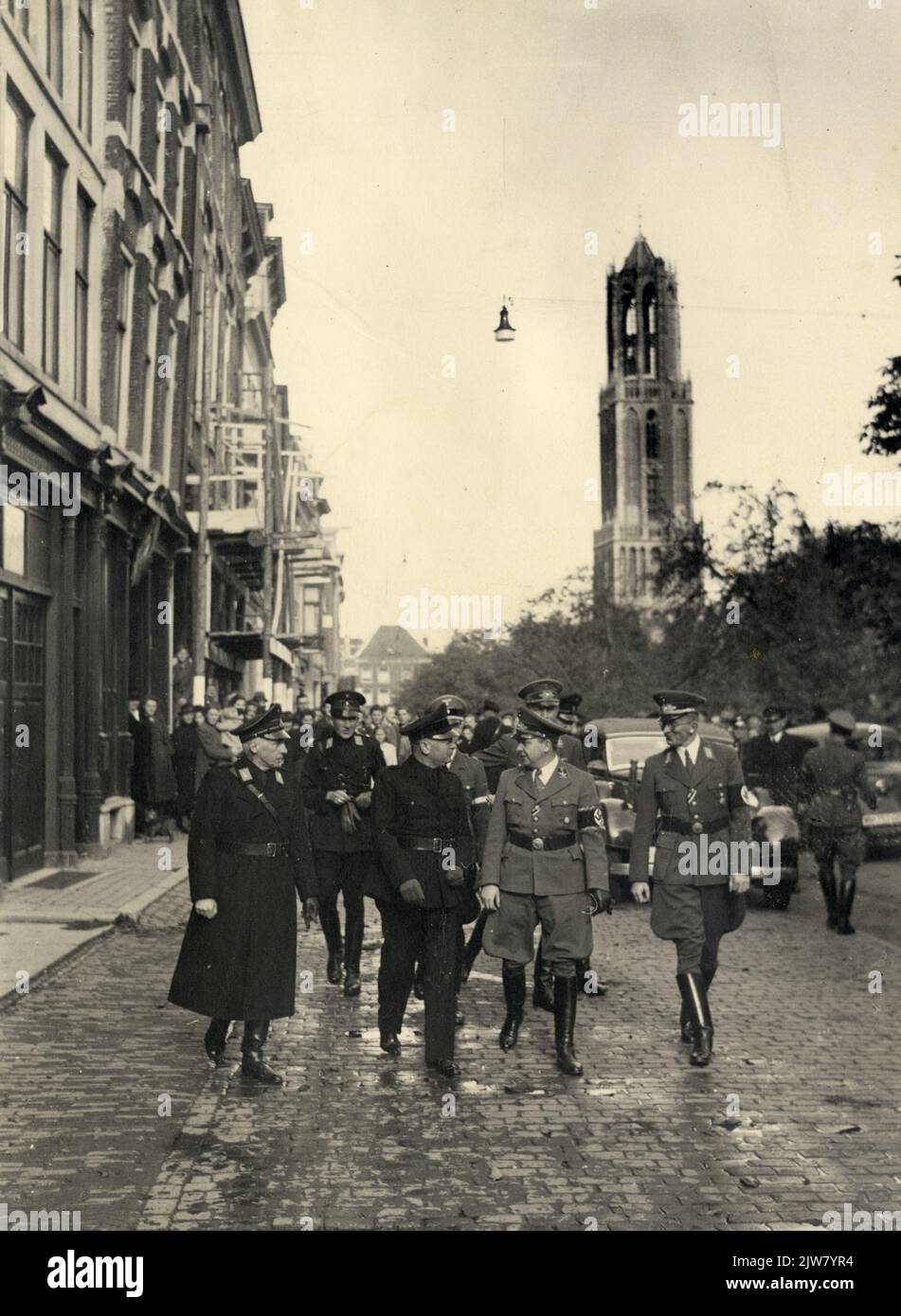 Image of v.l.n.r. prof.mr.dr. R. van Genechten (head of the educators' guild of the N.S.B.), Ir. A.A. Mussert, leader of the National Socialist Movement (N.S.B.), F. Schmidt (Generalkommissar Zur Besonderen Verwendung (special matters) and S.Sommer (Beauftragte in the province of Utrecht) on the way to the joint training meeting of the N.S.B. and the National-Socialist German Workers Party (N.S.D.A.P.) in the N.V. house (Oudegracht 245) in Utrecht. Stock Photo