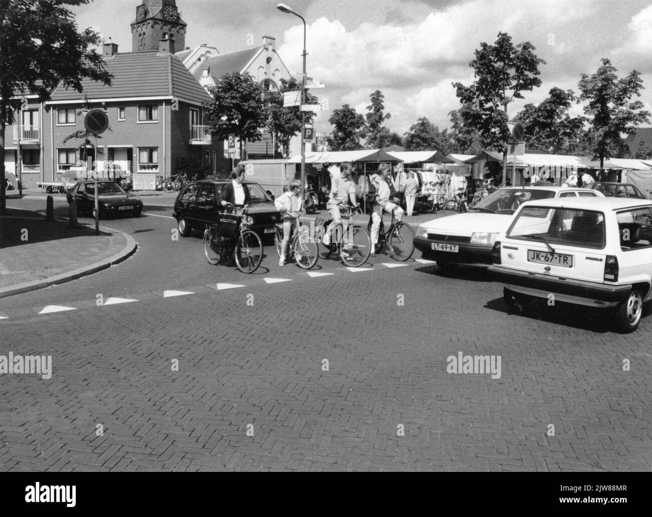 Image of the unsafe traffic situation for cyclists at the intersection of Stationsweg (left) and the Bosstraat at the Markt in Baarn; In the background the Pauluskerk. Stock Photo