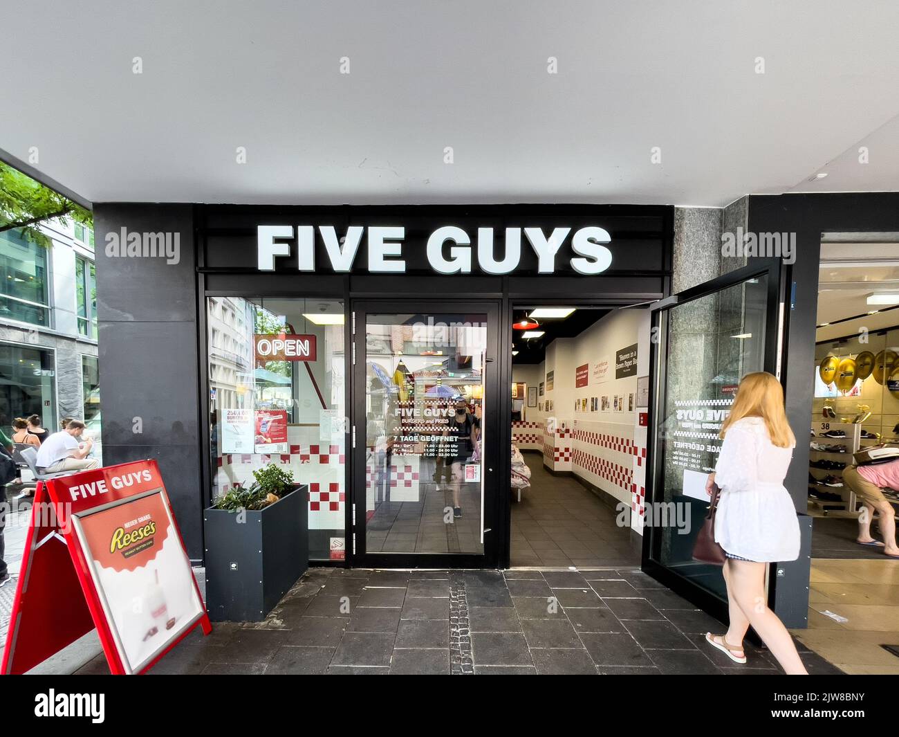Five Guys sign at a Five Guys Fast food restaurant in Munich town center Stock Photo
