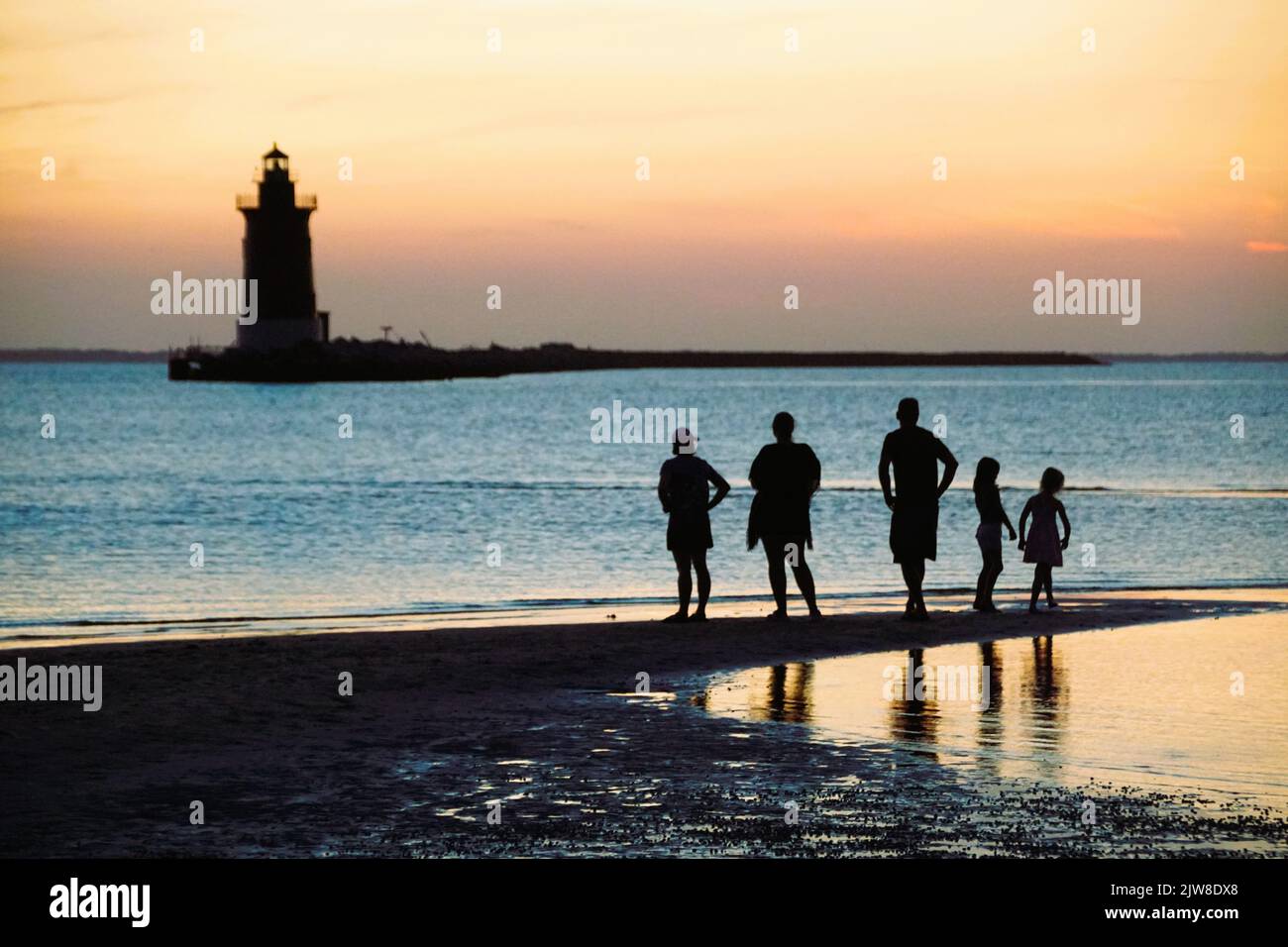 Silhouette of a family enjoying the sunset at Cape Henlopen State Park, Lewes, Delaware, U.S.A Stock Photo