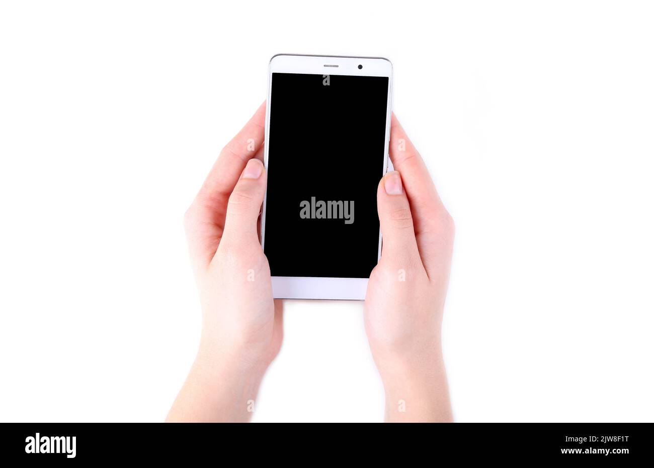 Female hands holding mobile phone with blank screen isolated on white ...