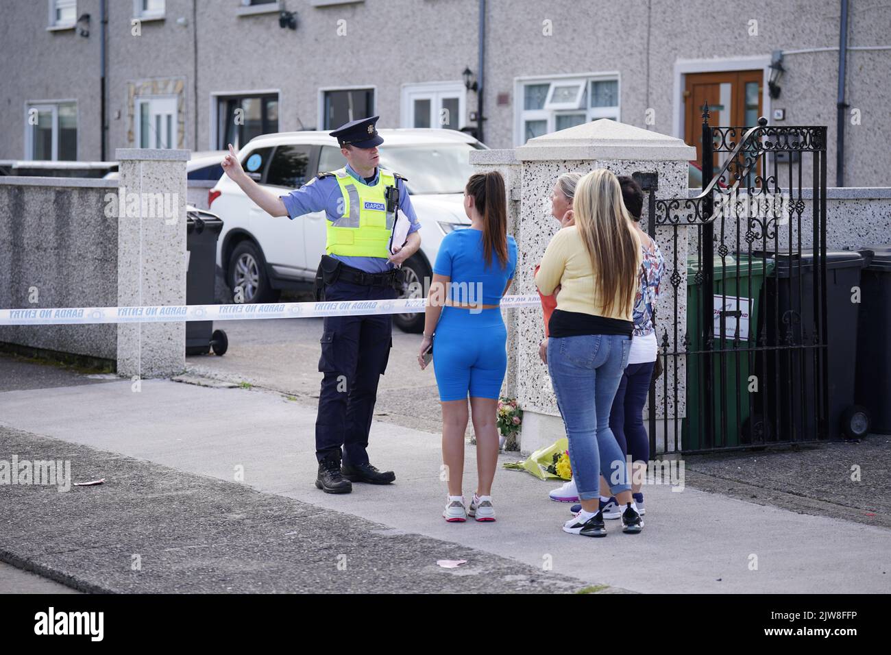 Local people speak to Garda at the scene in the Rossfield Estate in
