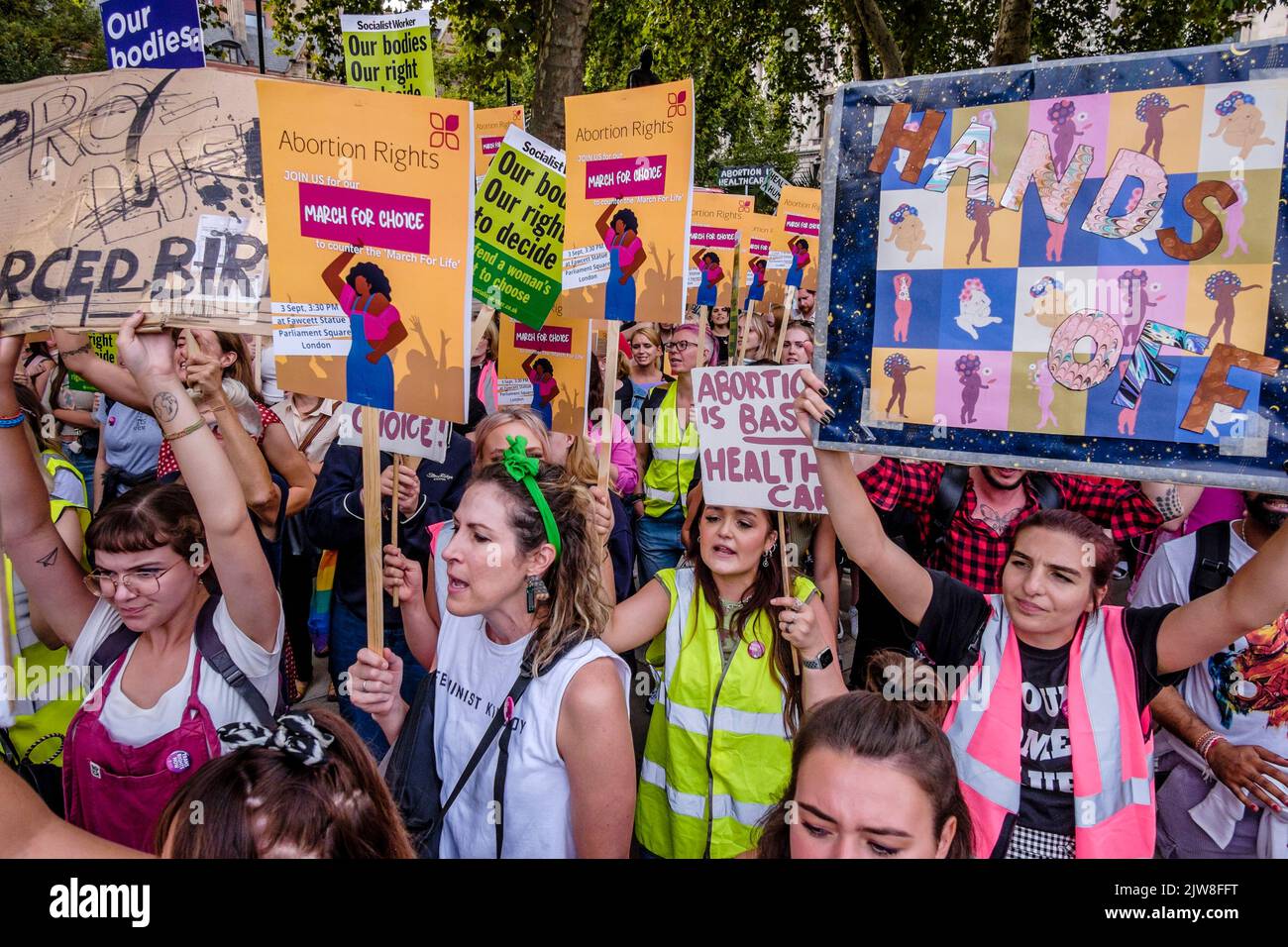 London, UK. 3 September 2022.  Pro-choice abortion campaigners display messaging of women's rights to choose during a March for Choice rally in Parliament Square in opposition to a rally also being held by anti-abortion campaign groups. Stock Photo