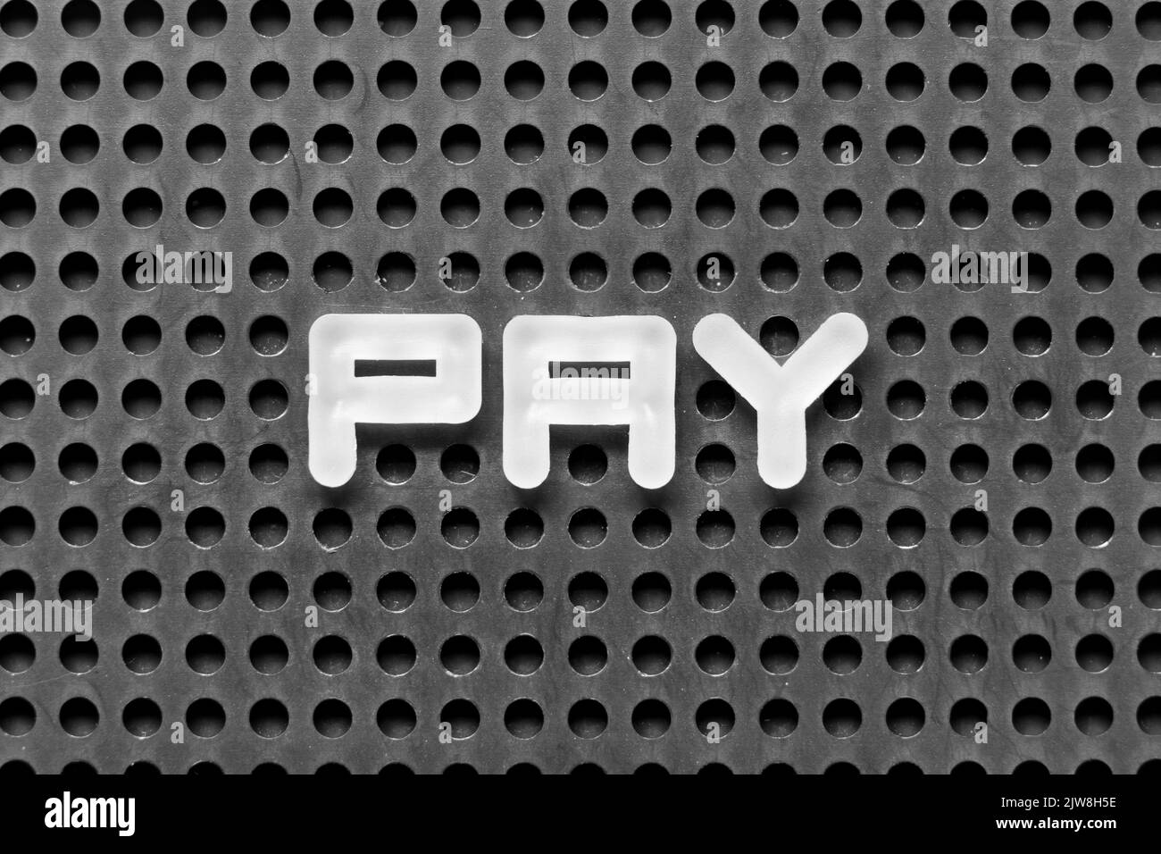 White alphabet letter in word pay on black pegboard background Stock Photo Alamy