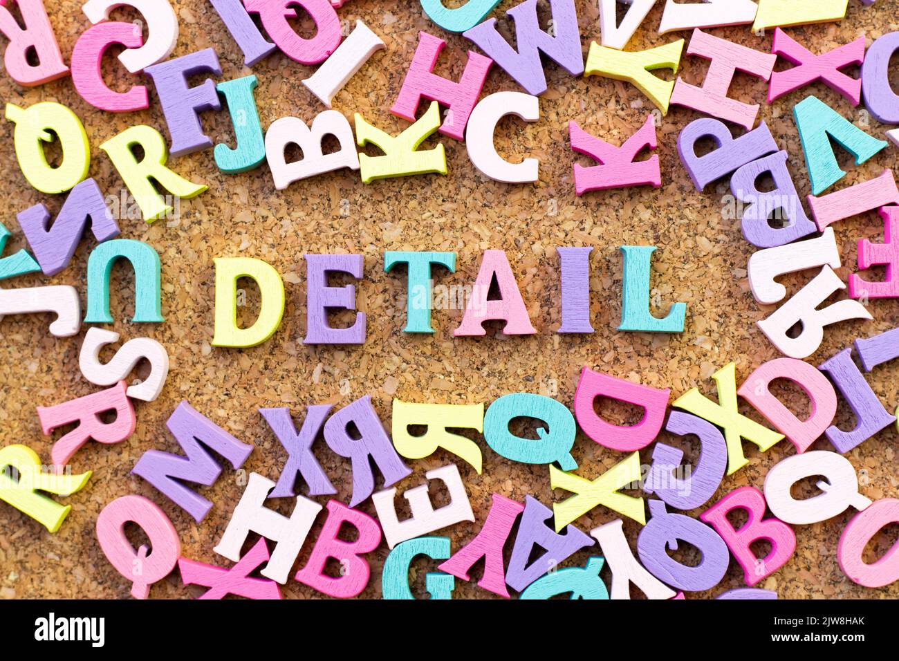 Color alphabet in word detail with another letter as frame on cork