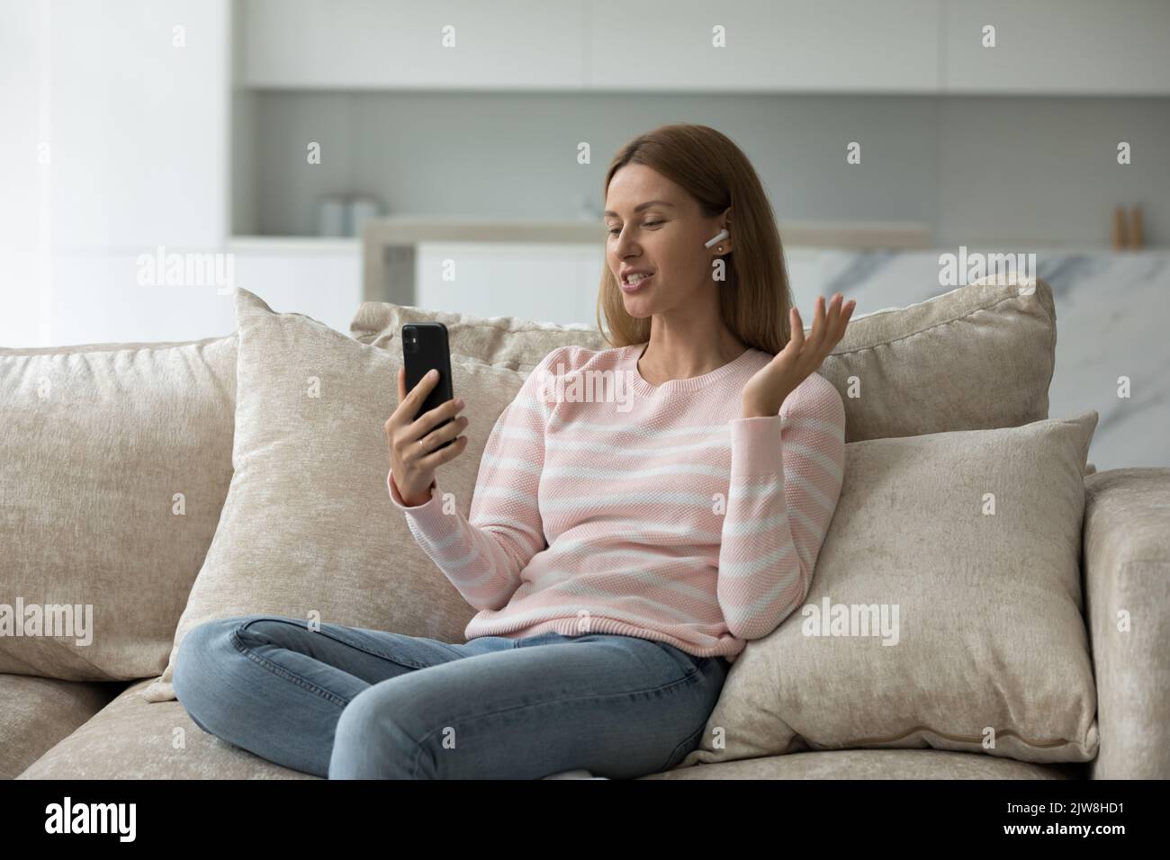 Positive millennial mobile phone user woman talking on video call Stock ...
