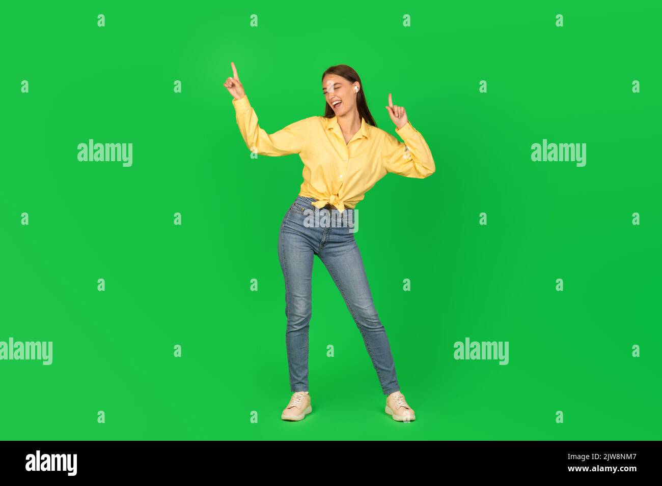 Young woman dancing over green hi-res stock photography and images - Alamy