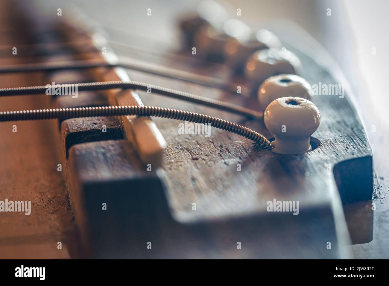 Acoustic guitar bridge and strings close up Stock Photo Alamy