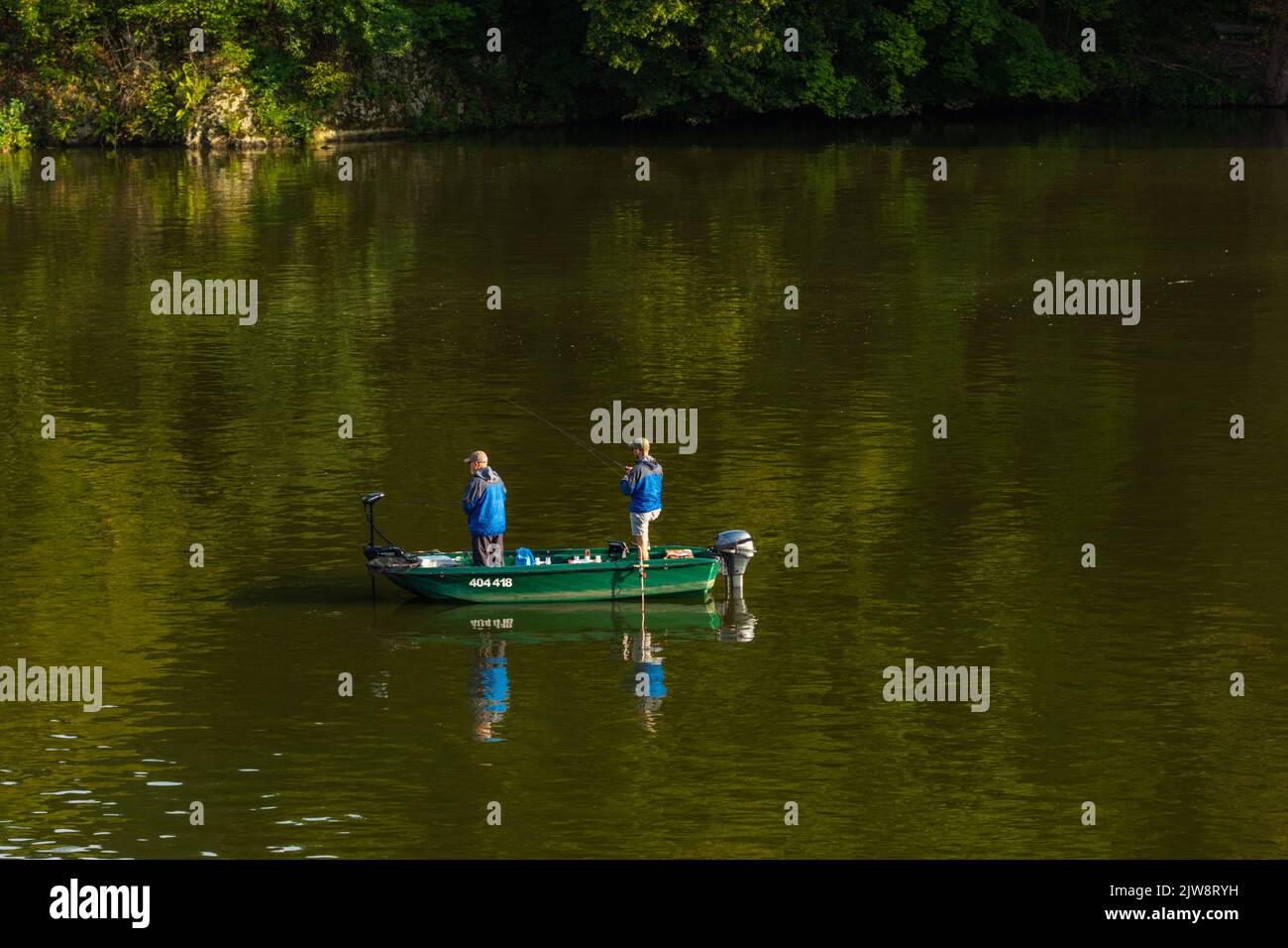 Fishermen in a boat catch fish on the dam Stock Photo Alamy