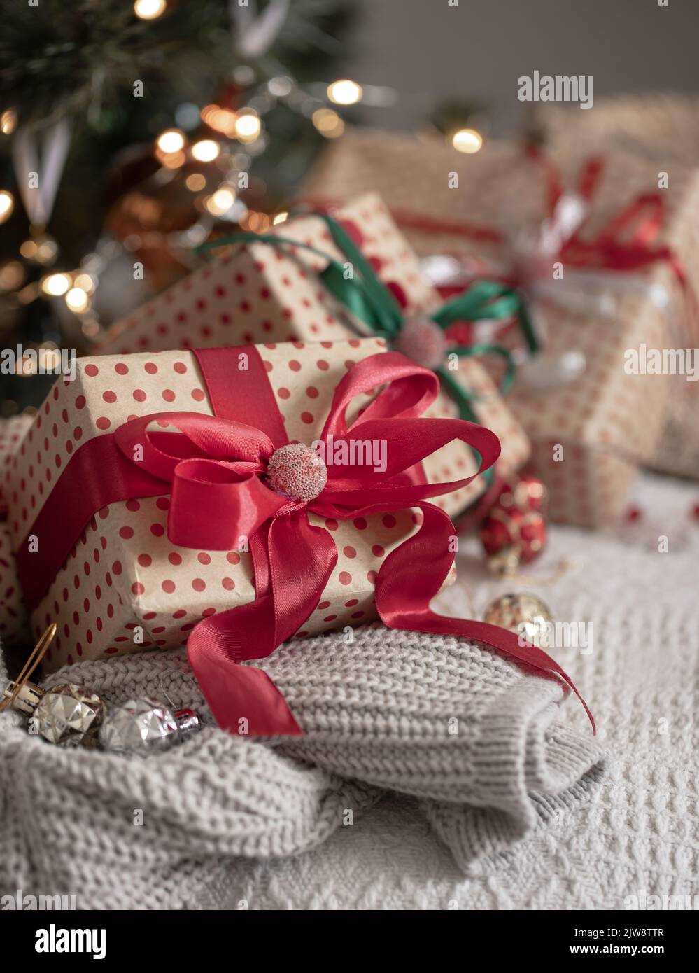 Festive gift boxes under the Christmas tree, close-up. Stock Photo