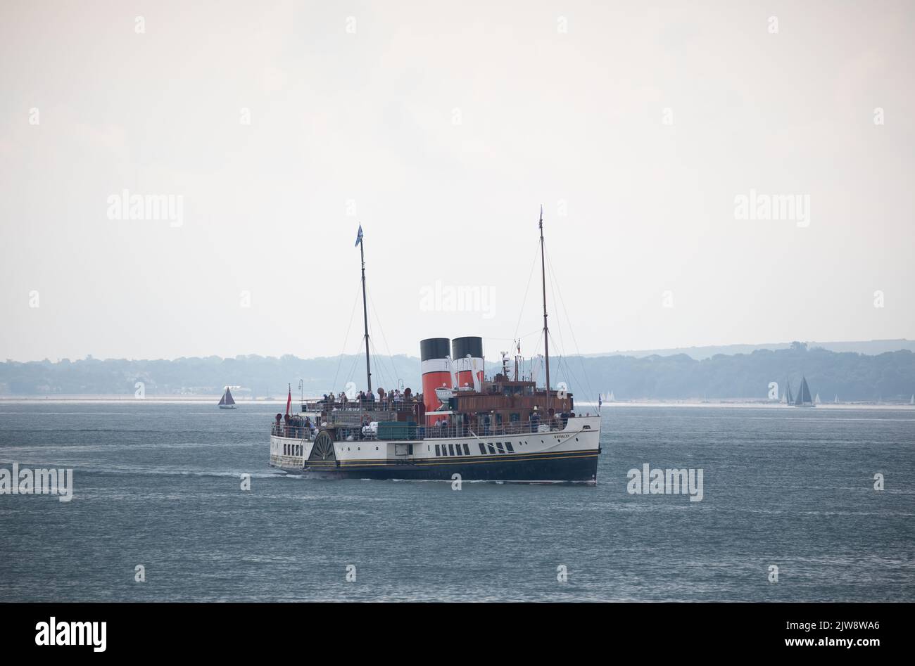 Paddle Steamer Waverley full of tourists on a day trip around the Solent. The only example of this type of vessel still operating. Stock Photo