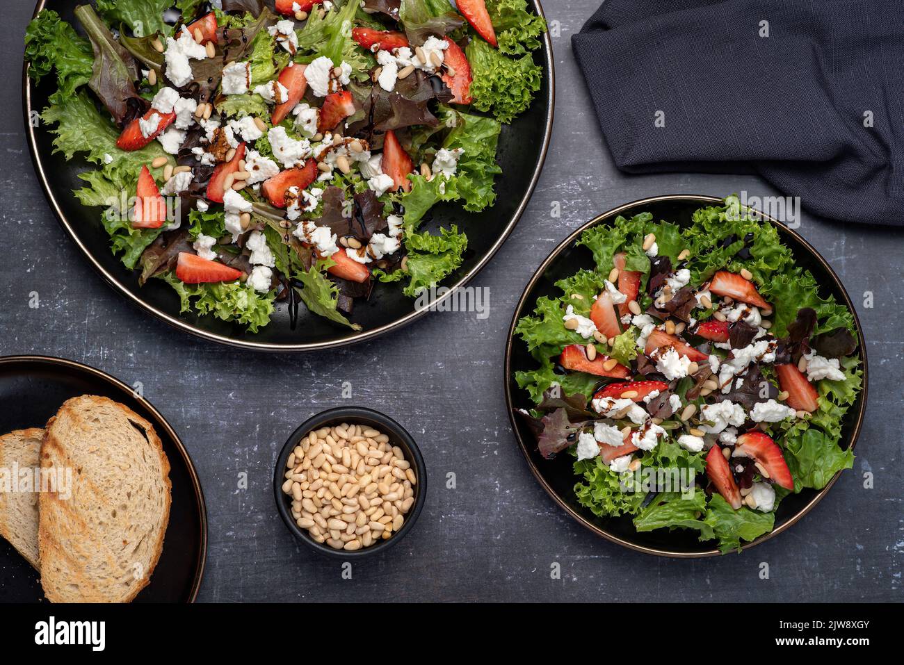 Food photography of goat cheese salad, lettuce, strawberry, pinenuts Stock Photo