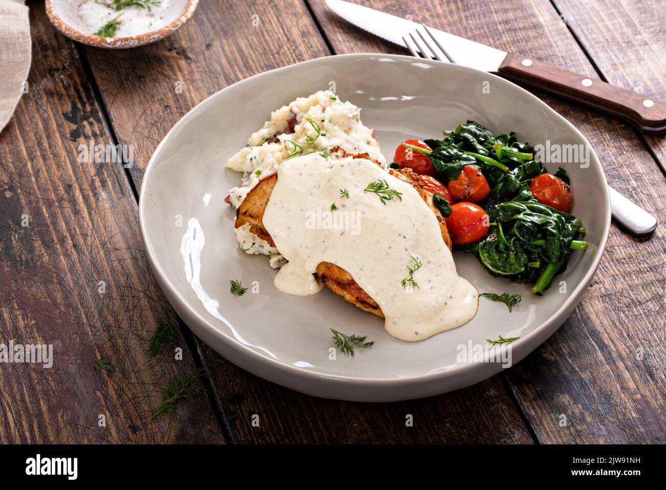 Roasted chicken thighs with dill pickle sauce Stock Photo Alamy