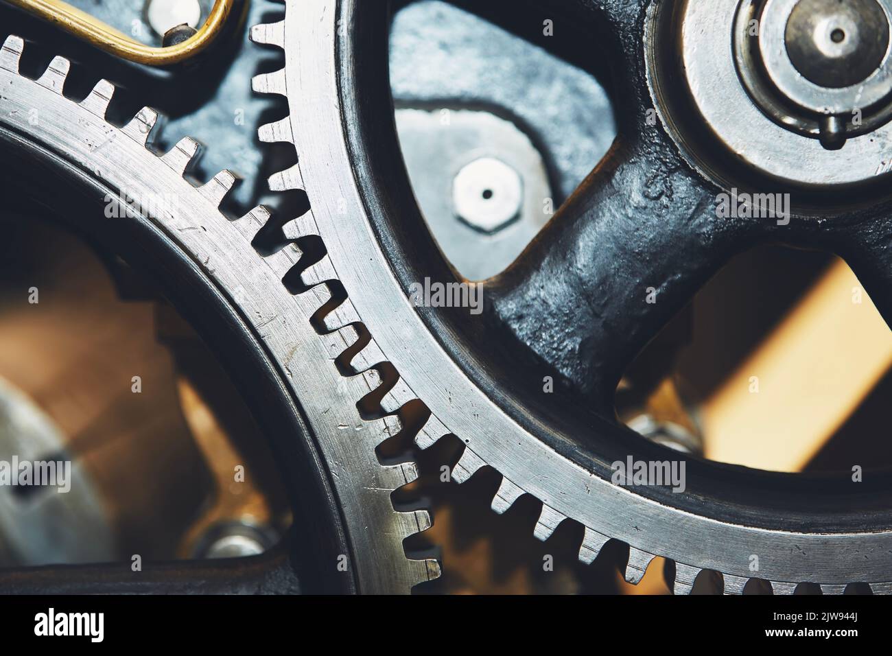 Close up of metal cog wheel in engine of machine. Stock Photo