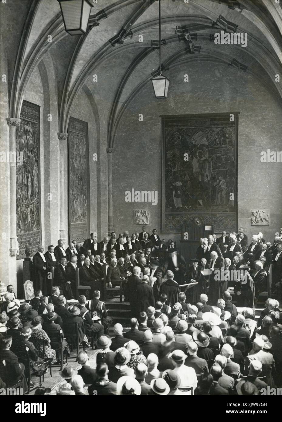 Image of the public session of the Academic Senate, in the Groot Auditorium of the Academy Building (Domplein 29) in Utrecht, during the presentation of 38 honorary doctorates, including to the Dutch. H. Kraemer, F.H. Fentener van Vlissingen, J.G. Remijnse, Prof.dr. P.C. Flu, C.A. Backer, Dom Jac. Huyben O.S.B., Dr. A. Vrijburg, Prof.dr. L. Otten, on the occasion of the 60th anniversary (300th anniversary) of the Utrecht University. Stock Photo