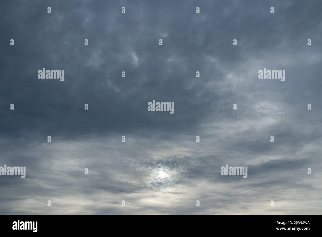 Photo of sun through stormy clouds. Stock Photo
