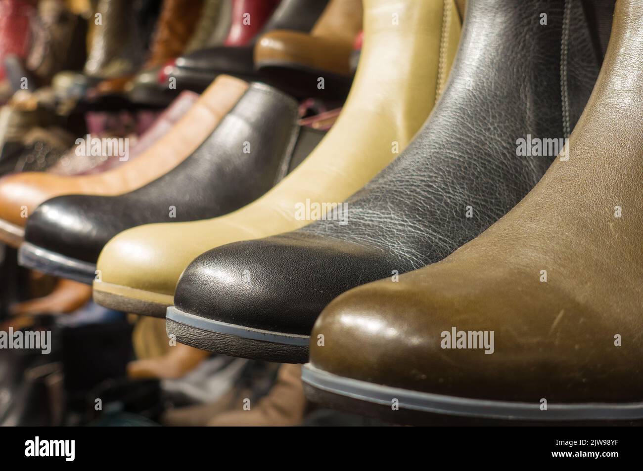 Photo of women's fashion boots in the store on the shelf Stock Photo